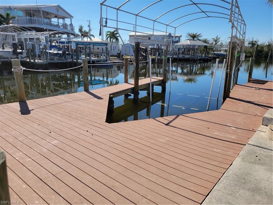 Great direct access lot. Cleared and filled to grade.   There are 2 lifts on property  1 an 8,000 lb lift the other 10,000 lift.   60 amp electric service at the dock.   
Owner owns all 3 lots in a row here.  Would discuss packaging 2 or 3 of them.  
Great canal direct access to bay then to Gulf of Mexico.