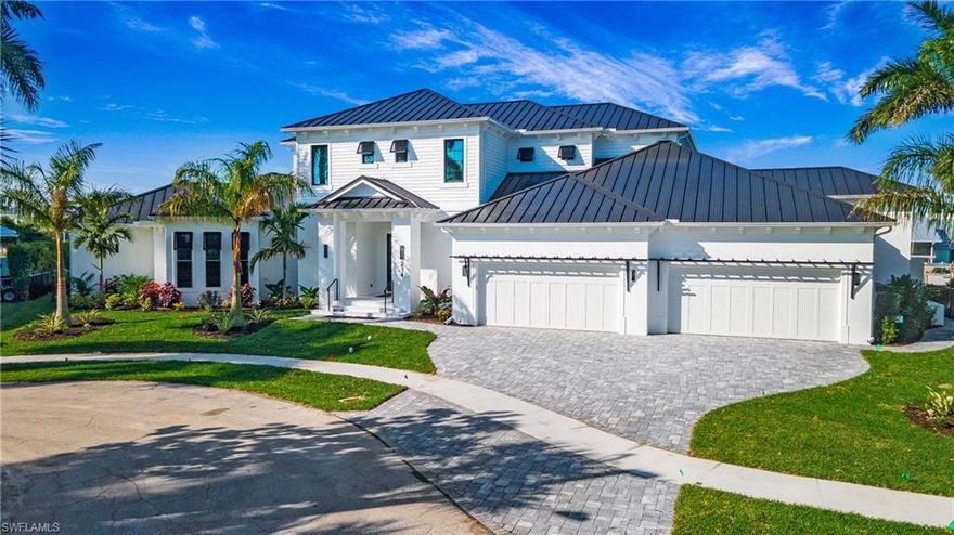 This elegant waterfront estate offers professionally designed luxury including a 4 car garage, 207' new seawall, and wide water views. With Southwest exposure and direct access to the Marco River, this home is a boaters dream. This family estate offers a large kitchen complete with custom Amish cabinetry and featuring stainless steel Thermadore appliances, including a professional gas range, and butler's pantry. Tucked away from the main living area is the master suite and luxurious bath, with walk through shower and massive custom closet. Also on the main floor is the unique casita living space for guests with a private entrance and en suite bathroom. Enjoy the water views on the second floor of this residence from the expansive terrace outside. Inside you will find a large family room with 3 additional bedrooms and 2 bathrooms. Delight in the alluring water views and magnificent sunsets from your heated pool and spa, the lanai, and the large covered living area. An outdoor kitchen, electric shutters and screens will enhance your outside living experience. Completion date April 25, 2024. Decorator furnishings included.