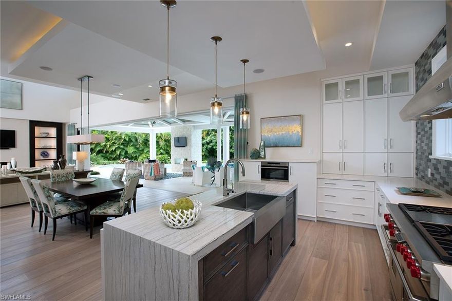 Perfectly positioned on a quiet cul-de-sac with an expansive, private outdoor oasis, this is truly Park Shore paradise. Exquisitely detailed by renowned designer, Lisa Ficarra, the coastal chic design is the ideal atmosphere to relax and unwind. Impressive, wide plank Legno Bastone floors seamlessly lead the eye to the serene covered outdoor area complete with fireplace, gourmet summer kitchen and a view of the resort like pool with spa, sun shelf and luscious greenery. The master suite leaves no luxury to be desired with custom Pecky Cypress and shiplap wall treatments, beautiful custom cabinetry and incredible walk through shower. With a stunning front elevation, 3 car garage, western exposure and close proximity to the Gulf Beaches, Venetian Village and downtown Naples, the idyllic Naples lifestyle is found. Residents of Park Shore will also benefit in the right to lease or purchase boat slips in the Venetian Bay Yacht Club.