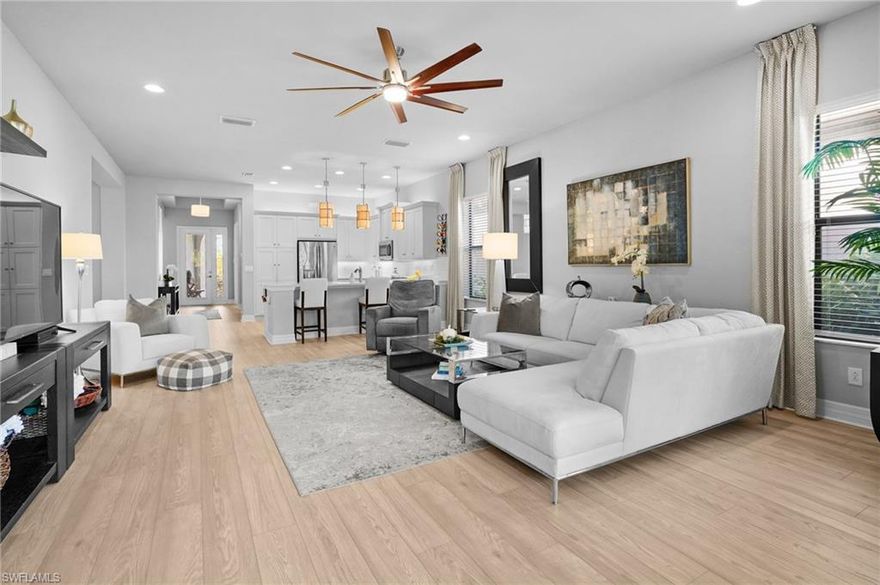 Built in 2018 and offered fully furnished, this exceptional residence is located within the prestigious, resort-style gated community of Marina Bay in the heart of Fort Myers, Florida. Originally a professionally decorated GL Homes model (spec home), this meticulously maintained property offers 3 bedrooms plus a den, 2.5 baths, and 2,242 sf of thoughtfully designed living space.  From the moment you enter, the home impresses with upgraded luxury vinyl flooring, a bright and airy open-concept layout, and expansive windows with custom drapery that invite in natural light. Designer finishes are showcased throughout, including upgraded lighting and elegant details that seamlessly blend comfort with sophistication. Lush tropical landscaping enhances the indoor-outdoor Florida lifestyle and provides an inviting setting for year-round enjoyment.  The chef’s kitchen serves as the heart of the home, featuring crisp white cabinetry, stunning quartz countertops, and an expansive breakfast bar overlooking the great room. A dedicated formal dining area creates the perfect backdrop for both intimate gatherings and elegant entertaining.  The primary suite is a true private retreat, offering a tranquil sitting area framed by bay windows, dual walk-in closets, and a spa-inspired ensuite bath with dual vanities, a soaking tub, and a separate walk-in shower. At the front of the home, a versatile den/office provides flexible living space, while two well-appointed guest bedrooms, a full guest bath with walk-in shower, and a stylish powder room ensure comfort and convenience for family and visitors alike.  Outdoor living potential abounds, with ample space to extend the lanai or add a private pool—allowing you to tailor the backyard to your personal vision.  Residents of Marina Bay enjoy unparalleled resort-style amenities, including a resort pool, lap pool, children’s splash area, state-of-the-art fitness center, clubhouse, indoor/outdoor basketball court, game room, tennis, pickleball and more. Ideally situated along Treeline Blvd, the community offers quick access to Gulf Coast Town Center, Miromar Outlets, RSW International Airport, Florida Gulf Coast University, Hertz Arena and the renowned beaches of Fort Myers Beach and Sanibel Island—all within 30 minutes.  This is more than a home—it’s a lifestyle. Schedule your private showing today and experience the very best of Southwest Florida living at Marina Bay.