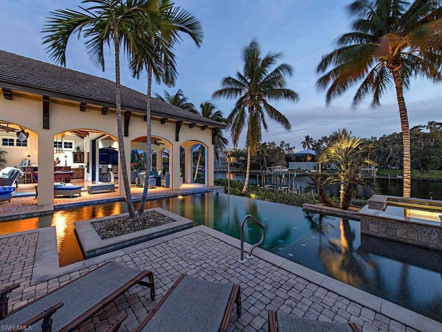 A magnificent home designed by Stofft Cooney & constructed by London Bay located in the exclusive 11 home community of Marina Pointe. Exquisite finishes & upgrades throughout, direct gulf access, private 13,000 lb boat lift, infinity edge pool w/50ft lap lane, palm tree framed river views, & unparalleled interior details. A private iron gated entry & brick laid driveway lead to an elevated entry of double mahogany doors where a masterful scene awaits w/ breathtaking views from every room & a floor plan punctuated by tasteful elegance at every turn. Vantage lighting system, solid wood flooring, custom bamboo ceiling accents, brick wine room w/ 7 ft subzero multi-zoned wine cooler, elevator to ensuite guest rooms, & electric lanai screens. An open kitchen boasts separate butler’s pantry, built-in crumb catcher vacuum, African granite counters, Subzero refrigerator, & Wolf appliances. Retreat to a master suite that will wrap you in luxury from the sitting alcove w/ river view or while indulging in a marble bath area complete w/ his/her vanities, soaking tub & separate walk through shower. Redefine the meaning of SW Florida living by making this one of a kind masterpiece yours.