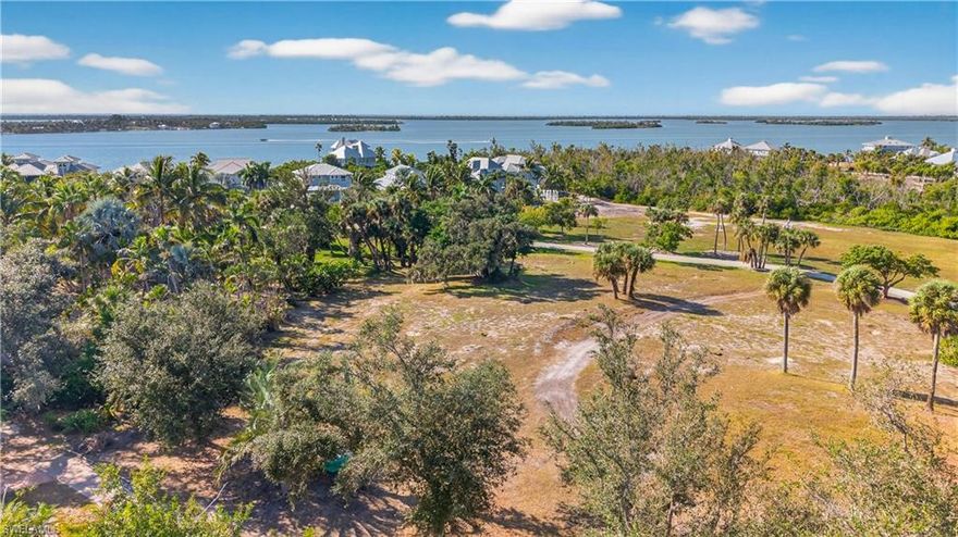 Located atop one of the tallest ridges in Lee County—possibly all of Southwest Florida—this building lot will offer impressive sunset views and sweeping water vistas stretching west and northwest toward Boca Grande Pass and beyond. The lot fronts the famous Pink Path extending from the north to south end of the primary island body and is proximate to historic archeological explorations and findings on Useppa Island. The Collier Inn restaurant, pool, tennis, bocce and croquet facilities are just a short stroll down the path, while your boat can be moored at the Useppa Marina, just 5 minutes on foot or one minute by golf cart. All public utilities are available and ready. Zoning allows either a single-family or two-family (duplex) structure and island covenants will require an Old Florida design. The site is in the X flood zone, above any potential storm surge. Homeowners on bridgeless Useppa Island are required to have membership in the Useppa Island Club and Marina. The 110-acre Sanctuary Island is a private community and members-only club. With no need for gates or walls, it is surrounded by water, in the pristine Pine Island Sound and Charlotte Harbor Aquatic Preserves of Southwest Florida. Geographically it is in the same chain of barrier islands as Sanibel-Captiva, North Captiva, Cayo Costa and Gasparilla Islands, one island east of the Gulf of America. Accessible only by boat (or aircraft), the commute to the mainland is in a special class of its own. Just a 15-minute boat ride will deliver you to Boca Grande or Pine Island, and thence to all “civilized” conveniences of the mainland. The commute is special in a way that you will never tire of it. Just think-you are not stuck in traffic, or waiting for a light to change, fretting over the packed roads ahead. You are just watching the dolphins play and the birds dive, waving to passing boats with smiling passengers, and all of them wave with more than one finger-joyfully! Yes, not like the mainland! You might be sitting next to one of your Useppa neighbors, the one that has not been in a grocery store for months, because all their goods are delivered to the Shore Port, where the staff will transport them to the island, and her home. Who said it is inconvenient when you don’t have roads?