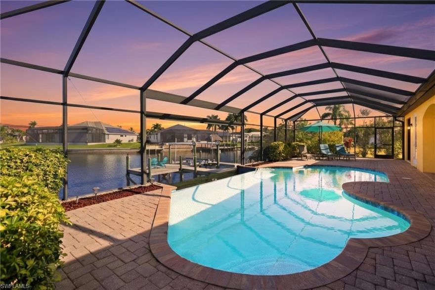 This turnkey, move-in ready luxury waterfront residence is in one of Southwest Cape Coral’s most desirable neighborhoods. Positioned on an extra-wide Gulf-access canal intersection, the home with its 90 degree sliders captures stunning intersecting water views from nearly every room and delivers an elevated coastal lifestyle designed for both comfort and versatility.
The residence offers over 2,200 sqft of living space and more than 4,600 sqft total area. The interior has been newly painted and furnished, allowing for immediate enjoyment. High-end finishes include travertine flooring throughout, a luxurious primary bathroom with a walk-through double shower, and an open, light-filled layout that seamlessly connects indoor and outdoor living.
The resort-style oversized infinity-edge pool is both solar heated and equipped with an additional electric heater, creating year-round usability. A private boat dock and expansive sundeck overlook the wide canal intersection, making this home ideal for boating, entertaining, and sunset gatherings.
The thoughtfully designed floor plan includes a primary suite with a king-size bed, a second bedroom with a queen-size bed, and a third bedroom with two twin beds. A fully equipped kitchen features stainless steel appliances, granite countertops, and bar seating. Additional highlights include a brick-paved driveway, concrete block construction, and a three-car garage that offers ample space for vehicles, storage, and boating gear. This property is being sold fully furnished and turnkey, making it an excellent option as a primary residence, seasonal retreat, or investment property. Private showings and virtual consultations are both available.