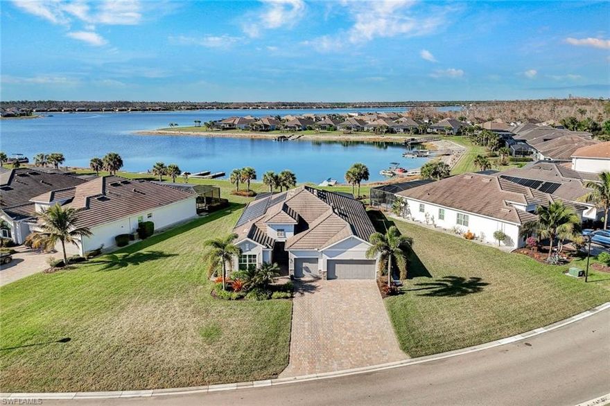 Welcome to exceptional waterfront living on an oversized pie-shaped homesite with a composite dock already in place—perfect for embracing the Southwest Florida lifestyle. This beautifully designed Summerville floor plan offers 3 bedrooms plus a den and 3 full baths with a desirable open-concept layout and split bedroom design for both comfort and privacy.
The spacious primary suite features two walk-in closets and a spa-inspired bath with dual vanities, a soaking tub, and a separate walk-in shower. At the heart of the home, the entertainer’s kitchen showcases an expansive quartz island with seating for four, GE Profile appliances, a dishwasher replaced in 2025, an additional beverage refrigerator, and elegant under- and over-cabinet lighting.
The home is equipped with dimming light controls and motion sensors for ambiance and convenience. 
In addition the home includes three TV's. 
Step outside to a spectacular screened lanai enhanced with a panoramic ClearView screen, allowing uninterrupted lake views. The outdoor living space is complete with a full outdoor kitchen, custom lanai lighting, and a solar hybrid heated pool and spa with a newly replaced pool pump—creating the perfect setting for both relaxation and entertaining.
The air-conditioned 3-car garage provides comfort and versatility, while a regularly maintained Generac generator offers added peace of mind. For added enjoyment, the home includes a two-person kayak with paddles, and there is an option to purchase a four-person golf cart.
Located within the highly sought-after community of WildBlue, residents enjoy a resort-style lifestyle with pickleball, bocce, tennis, and extensive water sports including kayaking, fishing, boating, and wakeboarding. The impressive clubhouse offers two restaurants with elegant indoor dining and a lively outdoor poolside bar featuring regular entertainment. A state-of-the-art fitness center, lap pool, and a full schedule of fitness and water classes complete the amenity experience.
This home is the perfect blend of waterfront serenity, thoughtful upgrades, and luxury community living—WildBlue truly has it all.