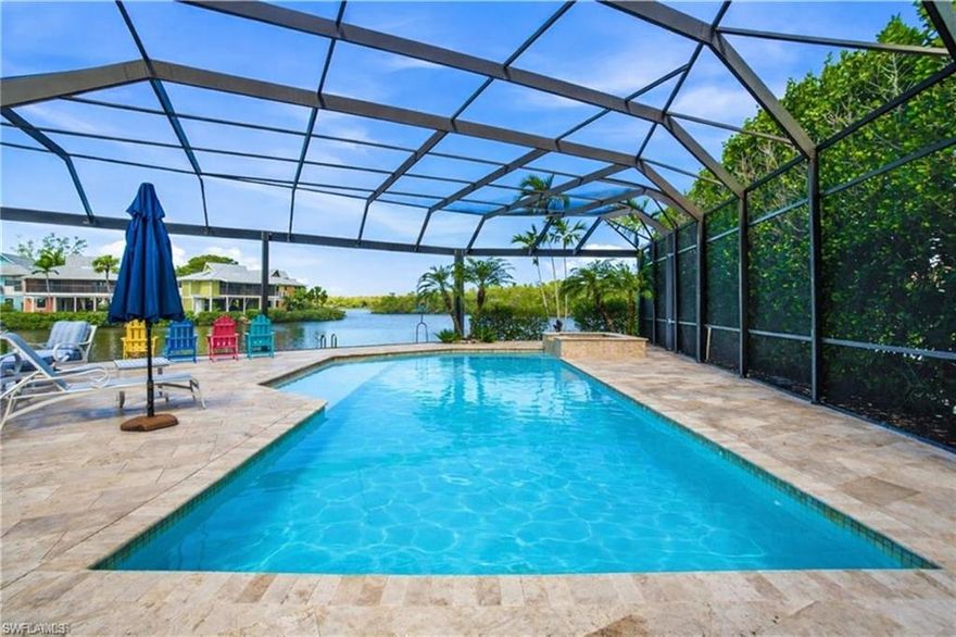BEAUTIFULLY AND COMPLETELY RENOVATED GULF-ACCESS HOME with stunning water views in a prime location West of US-41, less than a 10-minute bike ride to the pristine sands of Bonita Beach and Barefoot Beach! Boasting highly desirable WESTERN exposure, this property offers breathtaking sunset views over the water each evening. A true boater’s paradise, the home features 155 feet of water frontage, a large composite dock, a 10,000-lb covered boat lift, and quick Gulf access. Enhanced with numerous improvements and renovations over time, including updates to electrical, plumbing, AC system, and water heater, with the most recent renovation completed in 2024. Designed for peace of mind, the home also features a new exterior flood barrier system along and with new hurricane-impact windows and doors throughout. This coastal contemporary retreat offers 2,488 square feet of living space with 3 bedrooms + den, 4.5 bathrooms, dual laundry rooms, and a 2-car garage with an oversized paver driveway. Soaring vaulted ceilings and beautiful French doors fill the home with natural light. Step outside to your resort-style outdoor oasis, where an oversized screened lanai features a heated saltwater pool and spa (heated by solar or electric) along with ample lounging and entertaining space. All of this is perfectly framed by breathtaking water views where you can relax while watching dolphins, manatees, and boats glide by. Inside, the stunning chef’s kitchen showcases quartz countertops, an oversized 9-foot island, crisp white cabinetry, and high-end appliances. The primary suite offers private lanai access and features two full bathrooms along with its own dedicated laundry room. Each guest bedroom includes an ensuite bath, and one guest suite features a private exterior entrance for added flexibility and convenience. With no HOA fees or rental restrictions, this property also presents an excellent investment opportunity. Perfectly situated on a quiet cul-de-sac with minimal traffic and just a short walk to over a dozen local restaurants, this prime West of US-41 location offers convenient access to Bonita Beach, Barefoot Beach, RSW International Airport, The Promenade, Mercato, and Waterside Shops, along with a wide variety of casual and fine dining options.