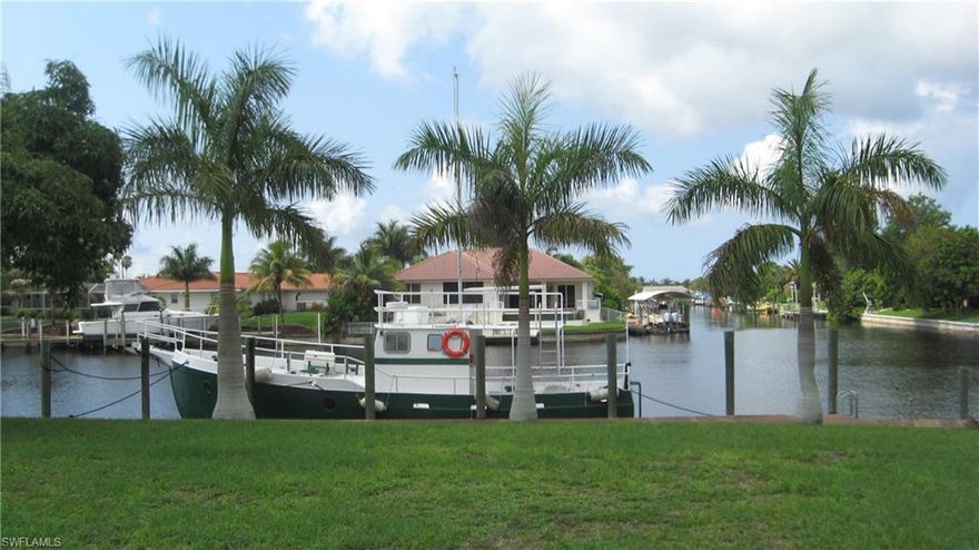 Price to sell - below market - Watch Dolphins and Beautiful Sunsets      Remodel or build new home on this large site with 310' of seawall in Palaco Grande Subdivision Southern exposure on 200' wide sailboat canal and 90'wide Rainbow canal on the side with wrap around dock for big boat and 10,000# boat lift.  This is almost a half acre and is approx. 10.5' above sea level with lots of royal palm trees   ( 10 min. to river )