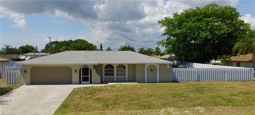 Motivated Seller!! $20,000 price reduction!! Schedule your showing today for this sought after Pelican Neighborhood home in beautiful Southwest Cape Coral. Having 2181 sf, makes this home one of the largest in it's price range for the immediate area. It sits on a fenced in 3 lot site with a rolling gate so that you can park your toys.  Home is on city water with all assessments PAID! This split bedroom home features 3 bedrooms with walk-in closets, 2 baths, living, dining, family, and laundry room.  You also get an fabulous bonus room that can be turned into a den, bedroom, or man cave. The open kitchen is great for entertaining family and friends. There are 2 disapearing sliders that lead to a large screened-in Lanai. Recent updates include a paved front patio, 1000 sf of dark wood laminate floors, tiled back splash, neutral paint throughout, ceiling fans, and more. The home is centrally located off of Pelican Boulevard and close to shopping, dining, and entertainment.
