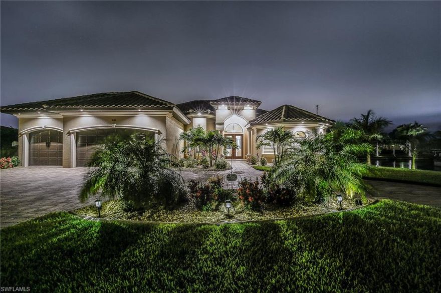 AGENTS DOWNLOAD THE EXTENSIVE LIST OF FEATURES This is a stunning, meticulously maintained LATITUDE 26 built home with exquisite finishes. Huge SOUTHERN EXPOSURE, INTERSECTING CANAL VIEW, GULF ACCESS lot w/NO LOCK access & 200 ft. SEAWALL. ALL ASSESSMENTS PAID. The circular paver drive & walk w/gorgeous landscaping leads to a spacious & luxurious home. All travertine flooring, 7” baseboards & crown molding throughout is just the start. The kitchen has custom cabinets, level 5 granite, 36” cooktop & wall mounted oven. Spoil yourself in the opulent master bath with two huge marble vanities, tub & magnificent walk though shower. All showers are travertine. Immediately upon entry, you will notice the 12' ceilings and LOW E impact glass throughout including the 10’ tall 90 degree corner slider leading you to a huge lanai with plenty of room for furnishings under the cypress ceiling & a summer kitchen w/refrigerator sink & grill. Plenty of room to lie in the sun around the lavish heated pool and spa. The state of the art security system has 10 cameras- View/review recordings, lock/unlock  door, control lighting and thermostat  from anywhere on your mobile device. A/C storage room too.