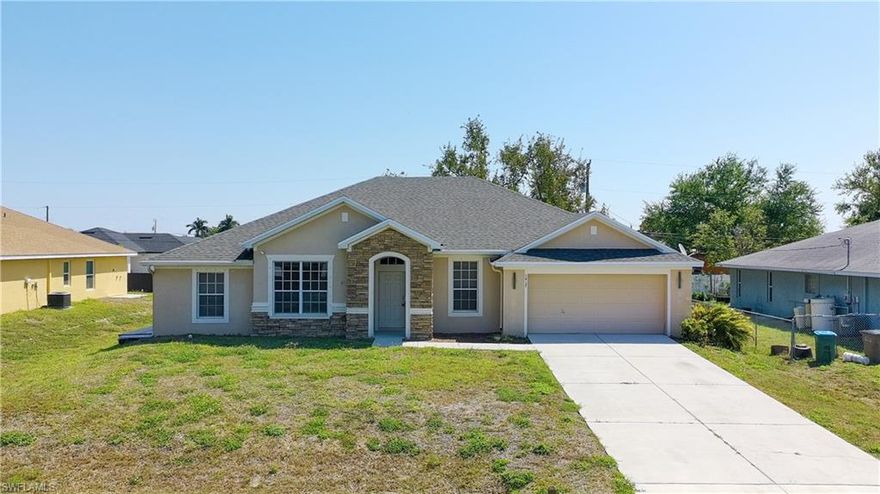 One or more photo(s) has been virtually staged, AI generated or rendered.  Seller offering a $5,000 credit toward buyer’s closing costs. This beautifully updated Cape Coral home stands out with a modern, open-concept design and high-quality finishes throughout. Enjoy brand-new tile and carpet flooring, updated lighting, and thoughtful upgrades in every room. The chef-inspired kitchen is a true centerpiece, complete with quartz countertops, a striking waterfall island with breakfast bar seating, pot filler, chef’s sink, pantry, all-new appliances, and timeless subway tile backsplash. The desirable split-bedroom layout provides excellent privacy, and the home includes a unique private side entrance with kitchenette—ideal for guests, extended family, or multi-generational living. Additional highlights include strong curb appeal, a newer roof, and a newer A/C system for peace of mind and low-maintenance ownership. Located close to shopping, dining, and all that Cape Coral has to offer, this property delivers exceptional value in today’s slower market. Motivated sellers—bring an offer. One or more photo(s) has been virtually staged, AI generated or rendered.