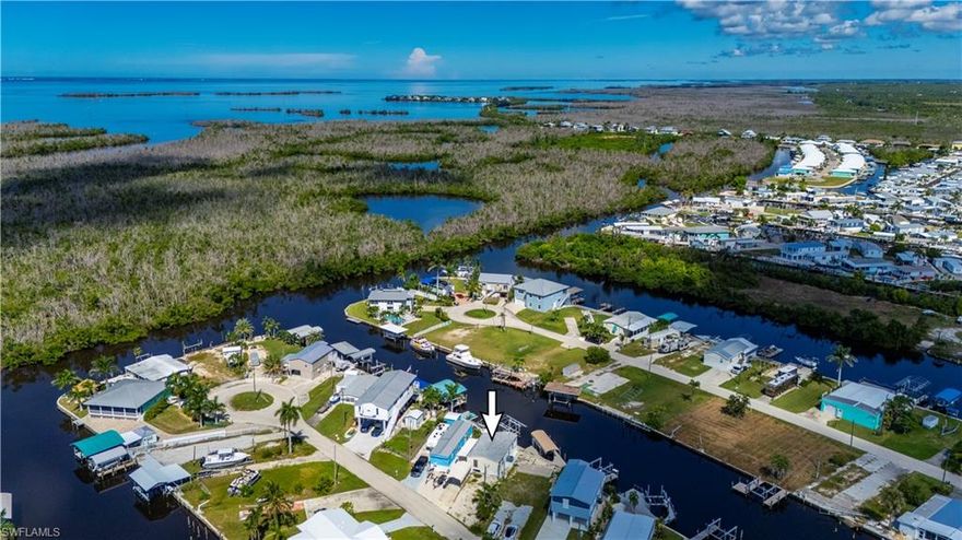 There’s a certain magic to life by the water-where mornings start with the call of seabirds and evenings end with painted skies over the canal. This 2 bedroom, 2 bath home in St. James City captures that timeless feeling of “Old Florida,” offering a simple, carefree lifestyle that’s becoming harder to find. Inside, natural light fills the space, giving the home a warm and cheerful personality. The space feels both quaint and comfortable-perfect for those seeking an affordable escape from northern winters or anyone who wants to slow down and enjoy life’s quieter pleasures. Step outside and the charm continues. A private dock with electric & water and 8,000lb boat lift makes it easy to set off onspontaneous fishing trips or explore the backwaters, Intracoastal, and nearby Gulf islands. The shed provides plenty of room for hobbies orextra storage, & the 11x21 carport adds convenient covered parking. Friendly neighborhood and a peaceful cul-de-sac setting add to the sense of community and ease. This is a place where memories are made on the water and every day feels a little lighter. With a little TLC, this classic Florida retreat offers wonderful potential; however, the property may have mold and/or moisture-related conditions. Buyers should verify all conditions through independent inspections.