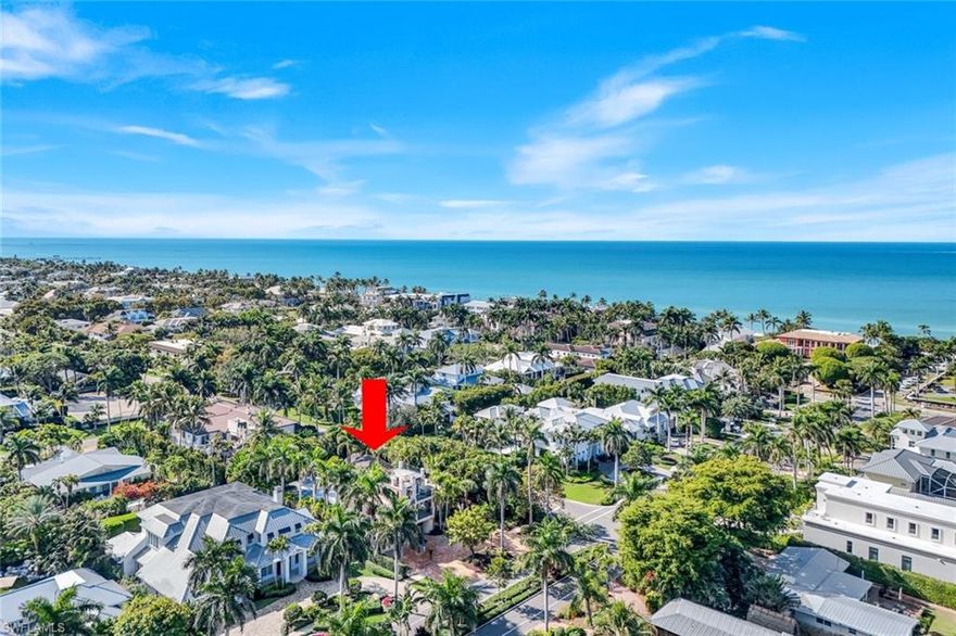 Just 5 houses from the beach this classic Olde Naples retreat could become your family compound for generations to come. Extensively renovated in 2005 and with a 3rd floor private guest suite added in 2011, it provides 5 bedroom suites all with direct bath access on 3 floors. The spacious 1st floor Primary bedroom is a private sanctuary with lux bath and direct access to the beautiful lushly landscaped pool and patio area. The 2nd floor features 2 large bedrooms with/ baths and a sitting area, the 3rd floor suite has access to a large tiled sundeck. Seeking the shade, move to the Tiki Hut adjacent to the family sized pool and deck. Privacy abounds within the mature landscaped property. The white island kitchen with premium appliances including gas range is open to the family room and dining area. Relax in the cozy living room with fireplace and access to cool breezes on the screened porch, later  enjoy cocktails in the nearby den with built-ins and wet bar w/ ice maker.  
This 150 x 100 corner lot with alley access also provides the perfect palate on which to create your Olde Naples  dream home. This home also has a strong rental history.