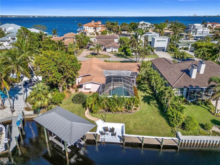 Wonderful boating property just minutes from the Caloosahatchee River! With over 65 lineal feet of Weardeck 2x6 composite dock (2021), a 10,000 lb boat lift with metal roof, Direct Gulf Access (no bridges) and a quiet setting at the end of a lovely canal, boaters will love this home. Additionally, a concrete dock provides an inviting waterfront sitting area. With the generous covered Lanai and the picture window screen cage (2016) enclosing the sizeable heated saltwater pool, this property lives larger than its listed square footage suggests. Providing a seamless transition to outdoor living, three sets of pocket sliders open fully to the Lanai and pool area, where you will find plenty of room for dining and relaxation. Inside, enjoy all the well-loved features of a quality Rutenberg home: the split-bedroom floor plan, the Kitchen as the heart of the home and sight lines focused on outdoor living spaces. Porcelain tile laid on the diagonal throughout the home provides design continuity and easy maintenance. The Kitchen boasts granite countertops, updated cabinetry including soft close drawers, newer stainless steel appliances, and a large window overlooking the pool with a pass-thru to the Lanai. Two spacious guest Bedrooms and a full Guest/Pool Bath are located on the opposite side of the home from the Primary Bedroom, providing privacy for host and guests alike. A Laundry Room/Office and Powder Room offer added practical living space. The lush, tropical landscaping includes several varieties of mature palms, a huge bird of paradise, a mango tree, and a bromeliad garden. Tall hedges adorn the perimeter creating a private sanctuary. Located in McGregor Isles, you're close to shopping, schools, medical facilities, and only 20 minutes from downtown Fort Myers, 15 minutes from Fort Myers Beach and Sanibel, and about 30 minutes to Southwest Florida International Airport (RSW). This is Florida living at its finest! Notable updates include water heater 2024, kitchen and appliances 2020, pool heater 2024, pool pump 2022, A/C 2018, tile roof 2013.