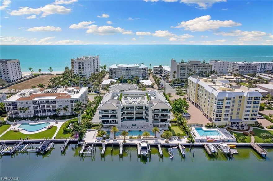 Welcome to your luxurious coastal retreat at 1820 Gulf Shore Boulevard North, Unit 301, Naples, FL. This stunning corner unit boasts 3 bedrooms, 3.5 bathrooms, and an expansive 2976 square feet of living space. Step inside to discover a chef's kitchen with an island, gas oven, and gas stove, perfect for culinary enthusiasts. The open kitchen flows seamlessly into the grand living area, accentuated by high ceilings and gorgeous moldings.  Enjoy the Florida sunshine from your private terrace with water views or entertain guests on the balcony.  This residence also features a private elevator, hardwood and tile floors, a wet bar, and a primary ensuite with separate shower and dual vanities. With 2 assigned covered parking and separate guest parking, convenience is paramount. Residents can also relish the benefits of a pool, rooftop deck for sunsets, golf putting area and a common roof deck. Embrace the epitome of coastal living in this exceptional Naples abode.This remarkable residence also includes the coveted feature of a boat dock, offering direct access to the sparkling waters of Naples. With the potential to add a lift, this amenity provides the perfect opportunity for boating enthusiasts to fully indulge in the coastal lifestyle.  Residents of this exceptional home have the added benefit of being right across the street from the beach, allowing for easy access to stunning sunsets and leisurely beach outings.