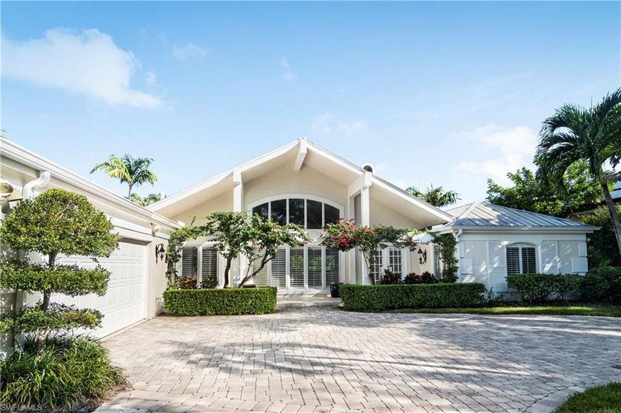 Aqualane waterfront home of casual elegance.  Exquisite for boating, beaching and strolling through historic Third Street for dining and shopping. Boat dock with lift. Summer kitchen with spectacular firepit on the dock for cozy, seasonal evenings.  Open floor plan with four private ensuites, living and family room accented by an inviting fireplace. Large sliding glass doors open to lanai and pool area and offer tons of light inside. Great entertaining home.