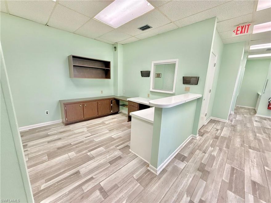 Step into opportunity with this beautifully combined 1,690 sq. ft. unit in the highly sought-after Landmark Building, perfectly positioned in the heart of Fort Myers. Originally two separate units, this space has been thoughtfully opened up to create a bright, spacious layout ready to suit your business needs.

Your clients will enjoy easy access with both an elevator and stairwell, while inside, the space is move-in ready with brand-new flooring, a kitchenette, and a private restroom. The welcoming waiting area with a built-in reception window makes a professional first impression from the moment guests arrive.

Whether you’re establishing your first location or expanding, this prime space combines convenience, visibility, and style—all in one of Fort Myers’ most recognizable buildings.