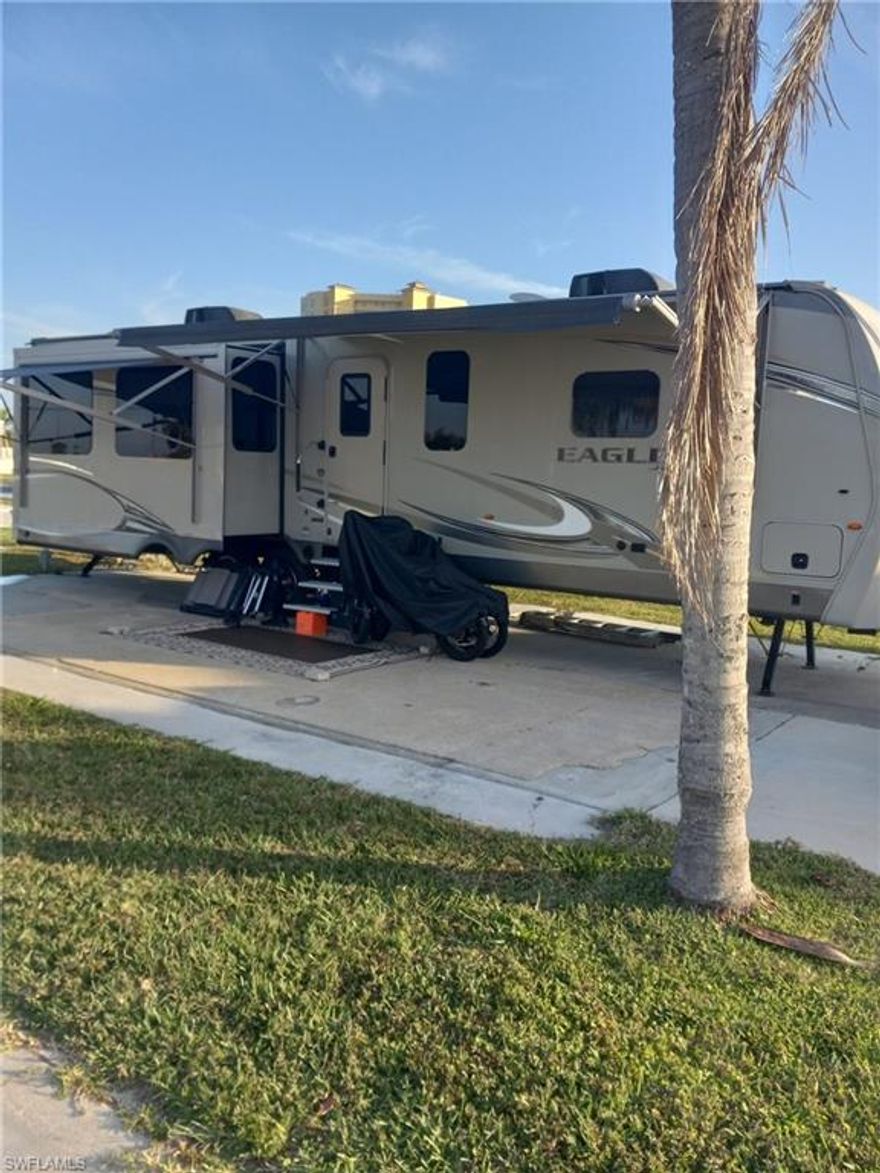 Palmetto Palms RV park is a gated, 55+ community where YOU OWN THE LAND!   2017 Jayco Eagle RV 40 Ft is located in Palmetto Palms. Electric, sewer and water. New electric hook ups. Never used, new interior updated furniture cost $2,000.   Spacious island kitchen has gas cook top, refrigerator, microwave. Sleeps 6, fireplace. Retractable sun awning, Everything in RV conveys in sale, except sellers personal items. RV treated in 2024 underneath for rust prevention. Property is located by pool and all amenities. With low HOA fees. Park offers boat storage and is biking or walking distance to Bunche Beach. Fort Myers Beach and Sanibel are a short car ride away. This area has so much to explore. Close walking distance to the community amenities including pool, tennis/pickle-ball courts, clubhouse. Near shopping and restaurants.