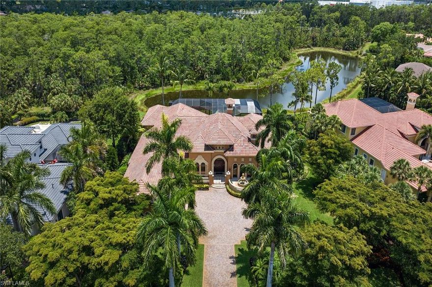 Imagine stepping into a sanctuary where luxury meets peace of mind, in one of the most serene and secure locations. This exquisite home, perched along a tranquil lake and lush preserve, ensures not only privacy but also abundant southern exposure that drenches the space in natural light. From the moment you enter through the grand double doors, you're captivated by a stunning three-panel window in the living room that frames the multi-level custom pool. This pool, complete with elegant fountains and cascading waterfalls, mirrors the beauty of the surrounding natural landscape. Every detail of this home has been thoughtfully designed, from the intricate coquina stone fireplace to the deep-set display niches that lend the living area an air of sophistication. Wander deeper into the home, and you'll discover craftsmanship that whispers luxury at every turn such as custom ceiling designs, coquina stone accents, and a walk-in wine room made from rich redwood, conveniently next to a wet bar. The chef’s kitchen is a masterpiece, with custom cabinetry, a dual-fuel range with double ovens and a hidden pantry behind a beautifully arched door. Entertaining here becomes an effortless joy, with pocketing sliding doors that open to a peaceful courtyard and 90-degree sliders that extend the living space to an expansive outdoor area. But this home’s charm extends beyond its aesthetics. It offers something invaluable such as hurricane protection and modern comfort. Impact-resistant windows and doors, combined with a whole-house generator, provide unmatched peace of mind during storm season. You can rest easy, knowing your home and loved ones are protected, no matter the weather. Outside, stone decking wraps around the pool, inviting you to relax by the water, or cozy up by the outdoor fireplace as the day fades. The primary suite offers a luxurious retreat, with triple-stepped coffered ceilings and custom cabinetry in the bath, ensuring every moment here feels indulgent. With four guest bedrooms, each with en-suite baths, and a charming study complete with an aquarium and marble fireplace, this home blends elegance with functionality. In the award-winning Mediterra community, luxury extends beyond your doorstep. Here, you’ll enjoy access to two Tom Fazio-designed golf courses, tennis courts, pickleball and a state-of-the-art fitness center. The private beach club, recently renovated, offers valet parking, sun loungers, a full bar, and alfresco dining, everything you need for an ideal day by the Gulf of Mexico. In this home, you’re not just investing in a property, you’re securing a lifestyle, one where peace of mind, elegance and the best of Florida living converge.