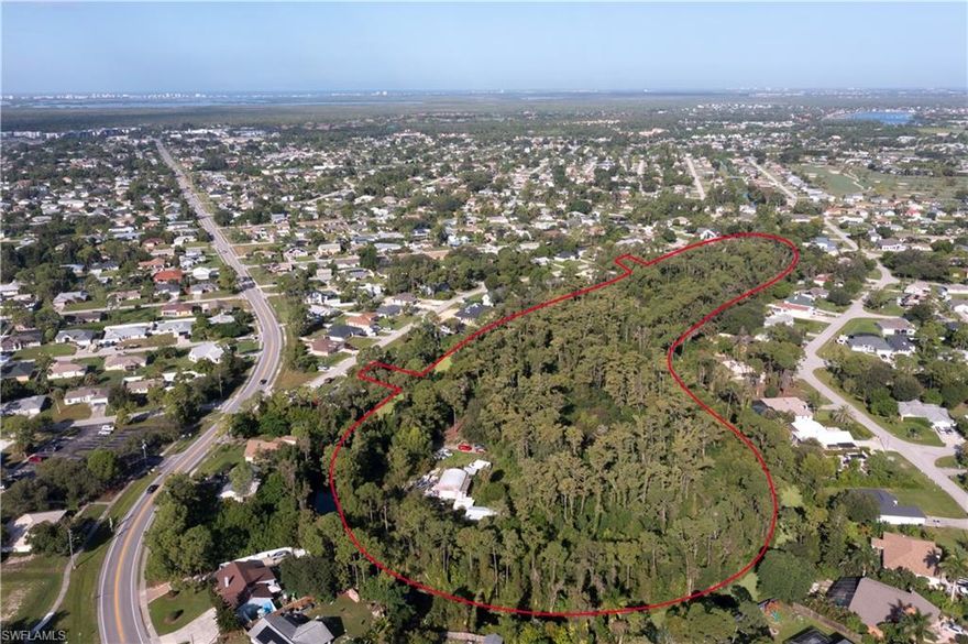 Discover a rare opportunity to own nearly 15 acres of prime land in Fort Myers, perfectly situated within the city yet offering a private, natural retreat. This offering includes contiguous three vacant lots being sold together, providing two access points for convenience and flexibility. The site is rich with Florida’s native flora, including mature trees and the iconic Dahoon Holly, and serves as a sanctuary for local wildlife. A recent survey shows only 0.66 of the property is wetlands and an environmental survey delineates minimal mitigation for full use of the 15 acres.  While remnants of previous structures, including an in-ground pool, spa, guest bungalow, carport, and gazebo, remain, the land is a blank canvas for new construction or creative development. This “inland island” setting offers a unique blend of seclusion and accessibility, ideal for buyers looking to craft a private estate with abundant space. Don’t miss the chance to secure this extraordinary parcel, combining location, history, and natural beauty in one exceptional property.