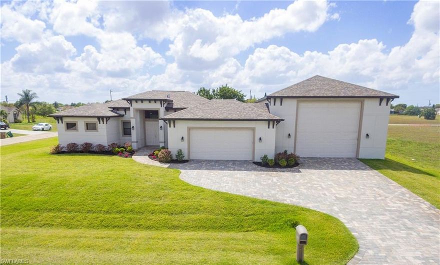 Calling all car enthusiasts, RV & business owners. Unique opportunity to own a move-in ready, custom built home with an attached, oversize finished garage with 14' high door! Elegant finishes, meticulous landscaping, and paver driveway elevate the curb appeal of this triple lot site. French doors enter into a bright open concept floor plan of over 1,800+ sq ft of living area with wood look tile throughout. Gourmet kitchen features stainless appliances, upgraded wood cabinetry with soft close features and plenty of quartz counters for entertaining. The master bedroom is a true retreat with private lanai access, tray ceiling and two roomy walk-in closets. Stunning spa-like master bath features a separate tub, spacious walk-in shower, dual vanities and linen closet. Two guest rooms and guest bath add to the flexibility of this home. Southern exposure, under-truss paver lanai and roomy backyard make this location a prime candidate for a pool. Situated on a corner lot with option to include the adjacent lot in the purchase (MLS 219020490). Located in Flood Zone X-no need for flood insurance! Potential seller financing or lease to purchase options-Ask your agent for details.