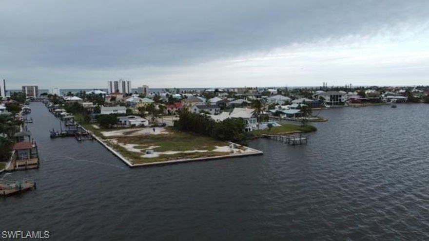 Enjoy beautiful sunrises from this oversized, cleared, homesite overlooking the widest part of Estero Bay.  Located on a quiet cul-de-sac and just a few blocks from the beach, this property has 475' of new seawall.