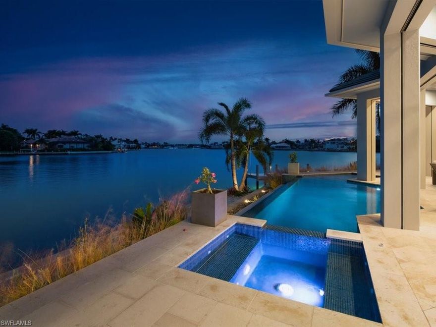 A dream is a wish your heart makes. Facing South over an open bay graced with blue green shimmering waters. 203 ft of seawall with 2 docks provide ample space for all your watercraft toys.
Relax on the lanai, watch TV, or take a dip in the heavenly infinity saltwater pool/spa while admiring dolphins, manatee and plentiful snook & tarpon. 
This home is complete with high end finishes that round out the gorgeous interior, including coffered ceilings, beautiful white marble, custom mill work that lend to an atmosphere of coastal elegance. 
Step outside to your own private studio that can be used as a home office, 4th bedroom, gym or mother in law suite. This amazing location is just steps away from shopping, dining, parks and the beautiful white sandy beaches of Marco Island.