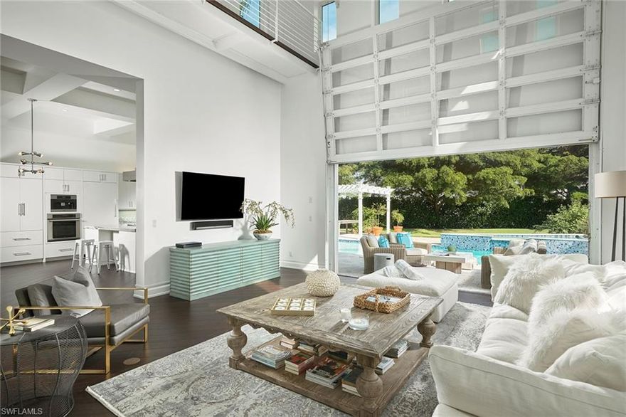 Contemporary with a dramatic twist that incorporates hints of industrial design, this house is ideal for entertaining and indoor/outdoor living at its finest. Perfectly situated, the spacious back yard design features a sprawling pool, spa and pergola surrounded by mature hedges and fruit trees allowing for the ultimate privacy. Large picture windows frame the front entry for light to fill the rooms and offer a dramatic entry for guests who will immediately draw upon the luxurious marble foyer perfectly detailed with hickory flooring insets. Large principal rooms and a chef’s dream kitchen open seamlessly to the dining area and share the main floor with a spacious master suite and light-filled den. Each of the three guest bedrooms have an en-suite bath and French doors leading to a wrap-around balcony and rooftop deck with picturesque sunrise and sunset views. All centrally located with easy access to the beach, downtown and the finest dining and shopping in Naples, this is your next paradise.