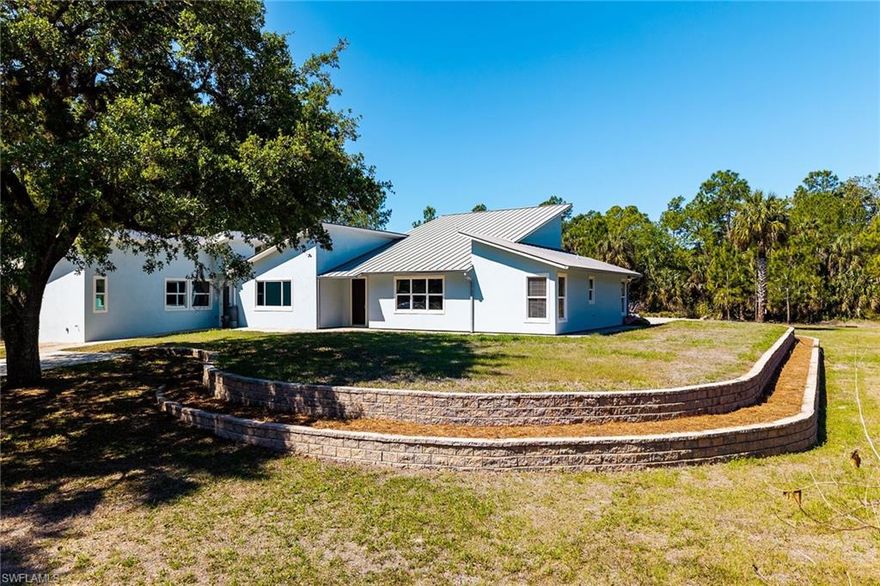 Begin each day with space to breathe, room to create, and the quiet privacy only acreage can provide. Set on 2.73 acres in Golden Gate Estates, this Naples property blends everyday comfort with the freedom to live how you want—whether that’s hosting under the shade of mature oaks, unwinding poolside, or tackling projects in your own workshop. The property offers two separate gated driveways allowing easy access to the rear detached garage/workshop. 
   Inside, 2,715 sq ft of living space offers 3 bedrooms, 2 baths, and a dedicated theater room for immersive movie nights. The high ceilings and spacious rooms bring the beauty of the outdoors inside. The large kitchen and dining room offers plenty of space for cooking and entertaining. The attached 480 sq ft in-law suite—complete with private entrance, full kitchen, and laundry—opens the door to multigenerational living or income potential. 
   Outdoors the pool and sun deck invites long afternoons in the Florida sun, while the detached steel garage/workshop and expansive paver area provide unmatched flexibility for storage, hobbies, or business needs. A rare blend of privacy, function, and opportunity. The rear driveway provides room for vehicles, toys, and projects, making everyday living easy, flexible, and expansive.
Major improvements include in-law suite added in 2020, updated ductwork in 2017, new heating unit in 2026, new pool pump in 2023, resurfaced pool in 2024, new septic drainfield in 2020, red iron steel building in 2017, master bathroom remodeled in 2024, guest bathroom remodeled in 2017, and theatre room conversion with separate mini split unit in 2020.