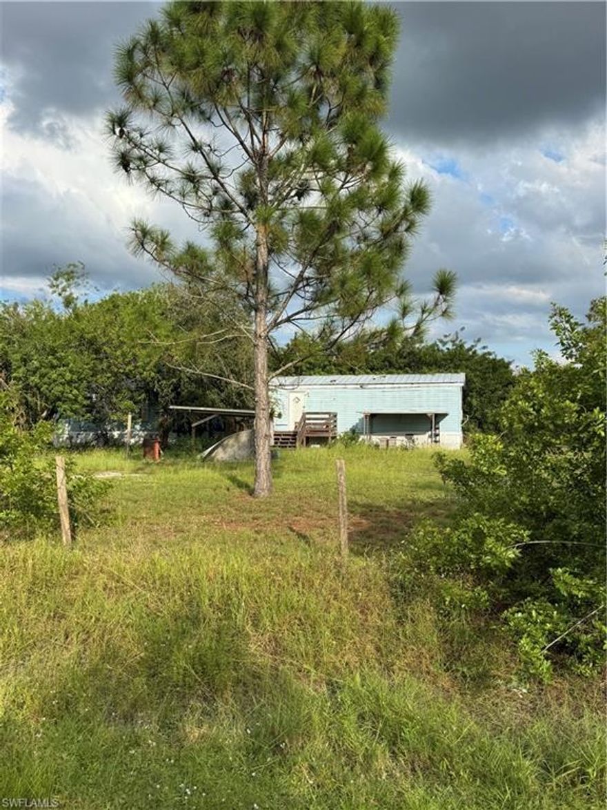 Rehabilitation opportunity on 2.5 acres with 3BR/2BA single-wide mobile home at the end of a quiet dead-end street. Ideal for investors or first-time buyers ready to create their vision of country living. Plenty of room for animals, gardens, or a small farm. Seller offers owner financing with 50% down, terms negotiable. Located approx. 1.75 hrs from Broward, Palm Beach, Sebring & Fort Myers. Montura Ranch Estates offers a grocery store, childcare, schools, gas station & more. Come take your own private tour!  (Adjoining lot 775 N Lindero Street is included in the 2.5 acres and can be negotiated separately)