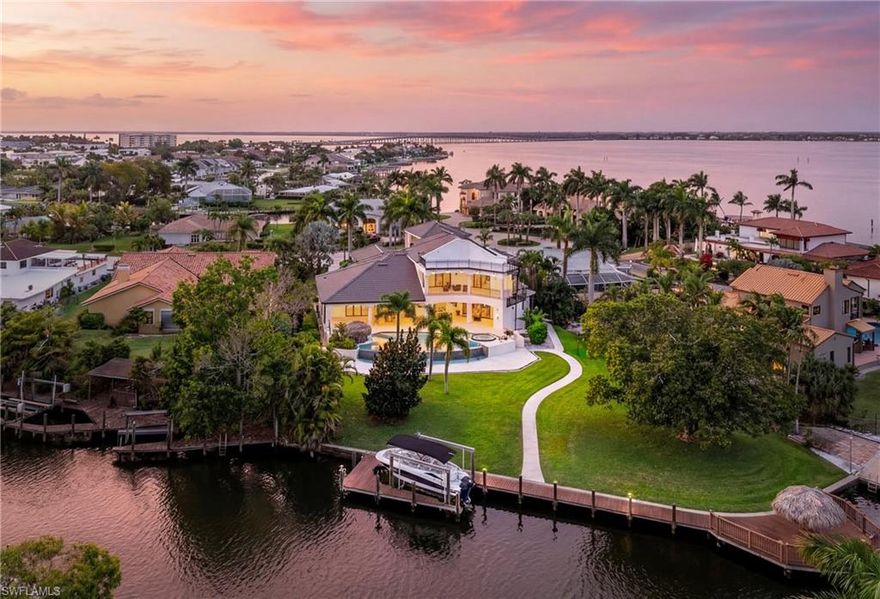 Modern Waterfront Masterpiece with Gulf Access enjoying south-west exposure.Welcome to 4944 Normandy Ct, an exceptional waterfront estate on an oversized canal-front lot with direct Sailboat Gulf access, no bridges, offering stunning southwest-facing sunset views.

This elegant two-story home features 4 bedrooms + den, 4 full baths and 2 half baths, with soaring ceilings, light-filled open living spaces and seamless tile flooring throughout. A grand foyer opens into an expansive living area with direct views of the outdoor oasis and waterfront beyond.

The home flows into a formal dining area and a sleek high-gloss white kitchen with black granite countertops and premium Miele appliances. A private entertainment lounge with bar and billiards adds a distinctive lifestyle element.

A custom staircase and a private elevator enhance both architectural elegance and comfort, while the home is fully wheelchair accessible and includes security system and safe.

Outdoor living is exceptional, featuring a resort-style pool with spa, outdoor kitchen and dining and living area as well as a tiki hut. The private dock with boat lift and additional tiki hut offers direct Gulf access and the perfect waterfront retreat.

Multiple balconies, including a large second-floor balcony and private guest balcony, as well as a rooftop terrace, provide stunning panoramic views.

Recent upgrades add significant value and peace of mind, including a new roof (2025), multiple A/C systems replaced in recent years (2025, 2024, 2021, 2019), and a new water heater (2026). Balconies have been newly paved, painted and insulated, the driveway has been partially upgraded in concrete, and the exterior of the home and all outdoor living areas have been freshly painted and resealed.

Additional features include solar panels and a 3-car garage.

A rare opportunity to own a modern Gulf-access estate combining luxury design, premier boating and exceptional indoor-outdoor living.