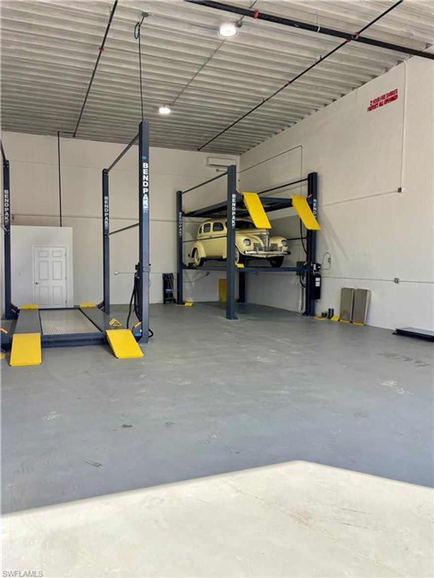 Exceptional Luxury Warehouse Unit in Toy Vault, Fort Myers!
Discover the pinnacle of luxury storage in this 1800 square foot warehouse unit at Toy Vault, Fort Myers. Ideally located just minutes from RSW Airport and Page Field, this unit offers year-round comfort with dual HVAC mini-split systems and 50-amp electrical hookups perfect for RVs. Enjoy peace of mind with 24/7 gated security, armed guards, and surveillance cameras, alongside solid concrete construction and hurricane-rated overhead doors. This Wi-Fi ready, fully customizable unit includes two BendPak automatic vehicle lifts, each capable of holding two vehicles, with all necessary equipment. Each BendPak lift is valued at $30,000. Additionally, at the asking price, the unit includes a 1939 Plymouth P8 car, as shown in the pictures. Residents can also enjoy a shared clubhouse with low CAM fees, making it a prime choice for luxury storage.