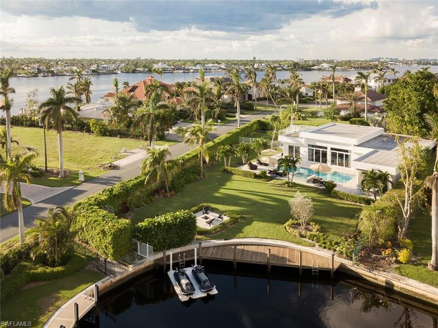 Fantastic water views over huge lawn yard from this recently built Olde Naples – Royal Harbor contemporary designer gem on a very rare oversized corner lot. You will love this very light and cozy Miami-style home on famous Naples Bay. 5th Avenue/3rd Street fine dining and shopping as well as beaches are just a short distance away from this quiet upscale neighborhood. Tennis enthusiasts will find challenging matches at nearby Cambier Park’s. Golfer will find a vast choice of public courses nearby. Royal Harbor is one of the top places to live in Naples. The beach, Tin City, Fifth Avenue and Third Street and plentiful Golf Courses are all right around the corner of this executive style residence. This turnkey 4-bed / 3.5-bath sleeps 8 (3 King, 1 Queen). Flat-screen TV’s in every bedroom. Gas-heated pool plus spa and screen shutter equipped lanai with gourmet outdoor kitchen facing desirable South. The entire oversized lot is protected by a mosquito mist system. Wireless SONOS stereo system inside/outside. Yard lighting. Rooftop sun & view deck featuring Naples Bay views. Hunter Douglas window coverings throughout.