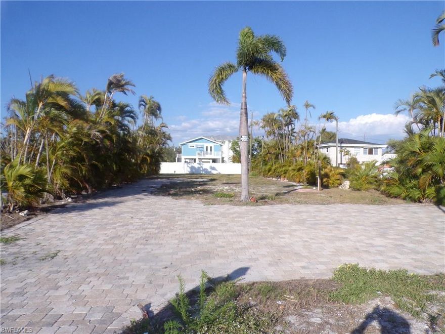 Do not overlook this amazing 150-foot-deep lot, complete with beautiful brick pavers and an outside spicket for outdoor shower, dog wash or car wash, already there waiting for your builder, to build you an amazing home. Almost across the street from Lanark beach access. Room for a pool, that would be built to suit your new home's elevation. This lot has partial gulf views of the Gulf of Mexico which is directly across the street. Wake up with the sunrise and spend your evenings watching the sunset, the lot is situated for both! Extra-long lots in this southern FMB area. Weekly rentals allowed, you decide if you want to rent to vacationers year-round, revenue that could gross you over a $100,000 a year or just have a brand-new home for yourself. Come be a part of the NEW Fort Myers Beach. You won't believe your eyes on all the new big, beautiful homes going up! There are only so many priced right, weekly rental Estero Blvd lot's left.