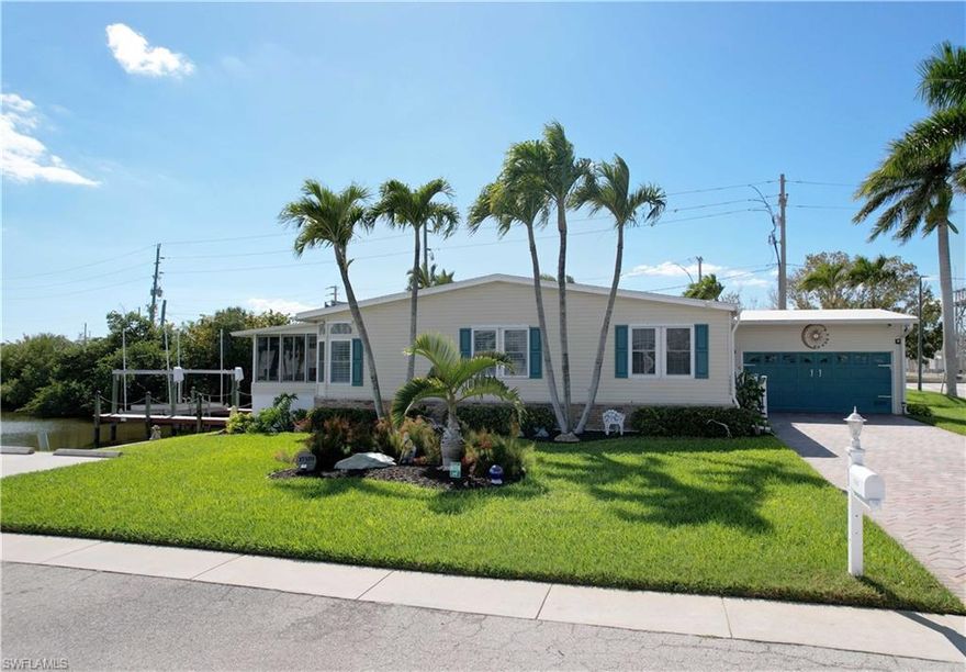 Rare opportunity at this price point to enjoy direct Gulf access with no lift system restrictions, ideal for larger vessels. Located in Bayside Estates, a highly desirable 55+ waterfront community, this property offers no bridges to open water along with a newer 16,000 lb boat lift accommodating up to a 40-foot vessel, over 90 feet of seawall, and ample waterfront to modify or expand the dock to accommodate an even larger boat with association approval… a rare advantage in this community. Situated on a private corner lot, the home features a two-car garage along with additional side parking added by the sellers, offering flexibility that is uncommon here. Lovingly maintained by the original owner, this spacious triple-wide manufactured home, built in 2002, offers the advantages of newer construction and more updated building standards. The home provides a wider, more open feel than most, with generous living space and oversized closets offering excellent storage throughout. Enjoy the convenience of keeping your boat right in your backyard while avoiding marina fees, often ranging from $700 to $1,400 per month for larger vessels, all just approximately 2.5 miles from the Fort Myers Beach bridge and about a 15-minute boat ride to Parrot Key… allowing for quick access to waterfront dining, open Gulf waters, and more time spent enjoying the boating lifestyle. From the enclosed lanai, enjoy peaceful canal views along with occasional visits from manatees and dolphins, as well as a variety of fish, birds, and other marine life that make waterfront living here so special. Bayside Estates offers a vibrant, active lifestyle with a full calendar of social events, boating activities, live music, and community gatherings throughout the year, along with a low HOA of approximately $700 per quarter including water, sewer, lawn care, and WiFi. Transferable flood policy in place and an extensive home warranty covering a majority of systems and components paid through October 2030… offering the opportunity to enjoy true Southwest Florida waterfront living with ease, convenience, and a strong sense of community.