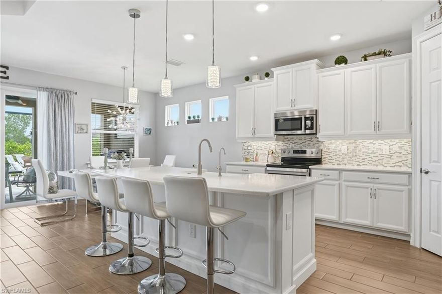 Stunning 4 bedroom + den residence in the desirable Seasons at Bonita offers a lakefront lifestyle with sweeping water views and exceptional outdoor living. This open concept home features a widened driveway, heated saltwater pool, fully equipped outdoor kitchen, hurricane impact doors and windows and a whole home water filtration system for added comfort and convenience. Bright, airy interior layout with generous living spaces, designer finishes and flexible den/office space to suit your needs. Located in a community that does not require flood insurance (saving thousands annually) and with low HOA dues, Seasons at Bonita delivers tremendous value. Resort-style amenities include tennis, pickleball, bocce, fitness center, resort pool, lap pool and dog parks. Don’t miss this rare combination of quality, location and lifestyle, schedule your showing today!