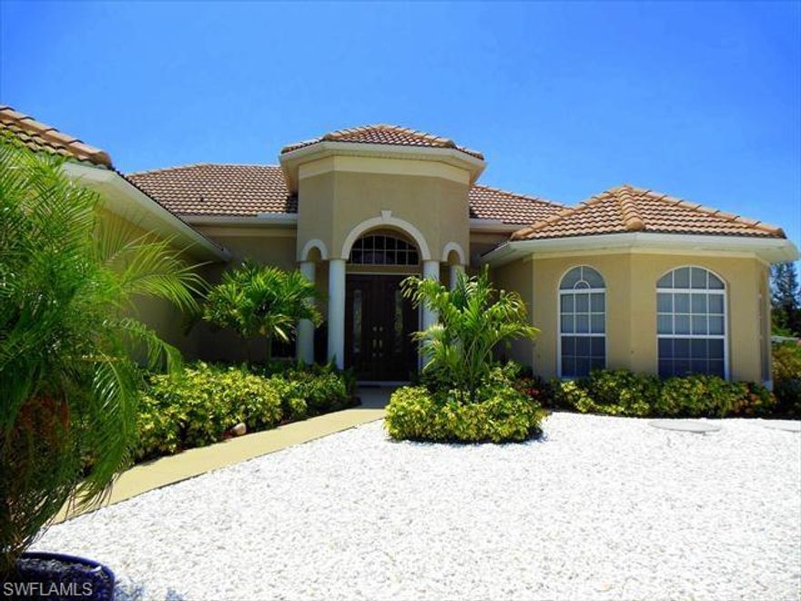 Just imagine gorgeous sunsets over a wide, private canal from a meticulously maintained, newer-built home with pool, spa, wraparound composite dock and 10,000lb boat lift. Featuring a Western exposure overlooking intersecting canals on the sailboat side of this quiet section of the Cape you'll find this 3 bedroom plus Den, 2 bath home with more than $100K in updates within the last 4 years. Interior features include tile flooring throughout the entire living area, granite counters, stainless appliances, a large Master suite with two walk-in closets and roman shower. All this and a view that what will delight you all day long. Catch blue crabs in the canal or watch the manatee and shore birds play. Natural breezes from the west keep the pool area cooler than most. The front features stunning wood-inspired entry doors with white granite and black marble landscape stone to make exterior maintenance a snap! Privacy, quality and location define this home - make an appointment to see it today!