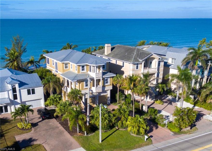 Direct beachfront 5 bed + den, 4.5 bath home, ideally-positioned for a sweeping Gulf view, from North to South. Enjoy the year-round-sunsets & sound of surf from one of the multiple Gulf-front lanais, with electric screens for both open-air or screened relaxation.  Pocketing sliders in the living room allow for seamless indoor/outdoor living & unobstructed Gulf views. Many new upgrades including brand new 2018 roof, new HVAC in 2014, new water heater 2017, all new stainless-steel kitchen appliances, new neutral paint inside & out, new tile in bedrooms & new double-story beachfront lanai with stairway to the beach. This home is sold turnkey with neutral coastal furnishings & is the perfect vacation home or rental income opportunity (fantastic rental history in-place).  Also includes electric storm screens, hardwood floors, soaring ceilings, spacious master suite with its own beachfront lanai, a private elevator, brick-pavered driveway & garage with room for 4 cars.  Walking distance to several fantastic restaurants & a 10-minute drive to Mercato & the Promenade, with Waterside Shops, Coconut Point, 5th Ave, and the International Airport nearby.