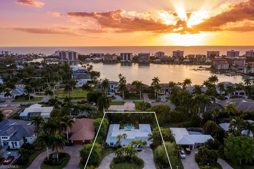 Highly desirable Moorings single-story residence is move-in ready and offers an unmatched lifestyle opportunity within walking distance to sugar sand Gulf beaches. Completely renovated luxurious kitchen and baths featuring timeless marble countertops, stainless steel appliances, beautiful plank tile floors, new roof and impact windows. A full wall of glass sliding doors leads out to a spacious covered lanai and lushly landscaped backyard with granite tile and a fully resurfaced sparkling blue pool. The secluded master retreat, with walk-in closet and private sitting area, features a custom Carrara marble shower, separate soaking tub, and dual sink vanity. Three additional en-suite bedrooms and a den provide comfortable and private space for family and friends. A tropical setting with Western sunset views, this home is eligible for the Moorings private beach access.