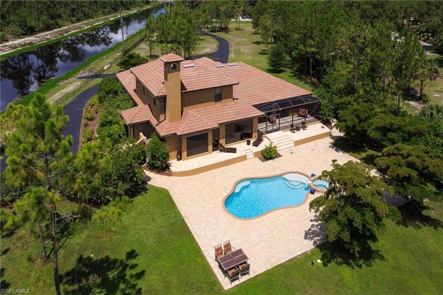 2008 WATERFRONT HOME BESIDE LARGE NATURAL PARADISE! Unwind as you enter the gates & drive down the 400' paved driveway to your custom built 4000sf home, 5 bedroom, 4 bathroom, 4.42 acres, 2.5 car garage.  Spectacular view of a STUNNING LARGE RIVER & THE NANCY PAYTON NATURE SANCTUARY running down the 600 FOOT length of the FENCED property.  LARGE PRIVATE BOAT RAMP with direct access to many miles of large canals that are excellent for FISHING.  Complete privacy around the whole property.  HIGH END FINISHINGS with EXTENSIVE GRANITE AND MARBLE throughout, travertine fireplace, luxurious interior, oversized POOL & massive pool deck, NEW state of the art salt water heated pool, Jacuzzi, outdoor kitchen on lanai, NEW whole home reverse osmosis system provides bottled water quality throughout home, HORSE CORRAL in back of property (miles of wide HORSE/WALKING TRAILS directly across the river).  ABSOLUTELY BREATHTAKING VIEWS AROUND ENTIRE PROPERTY!