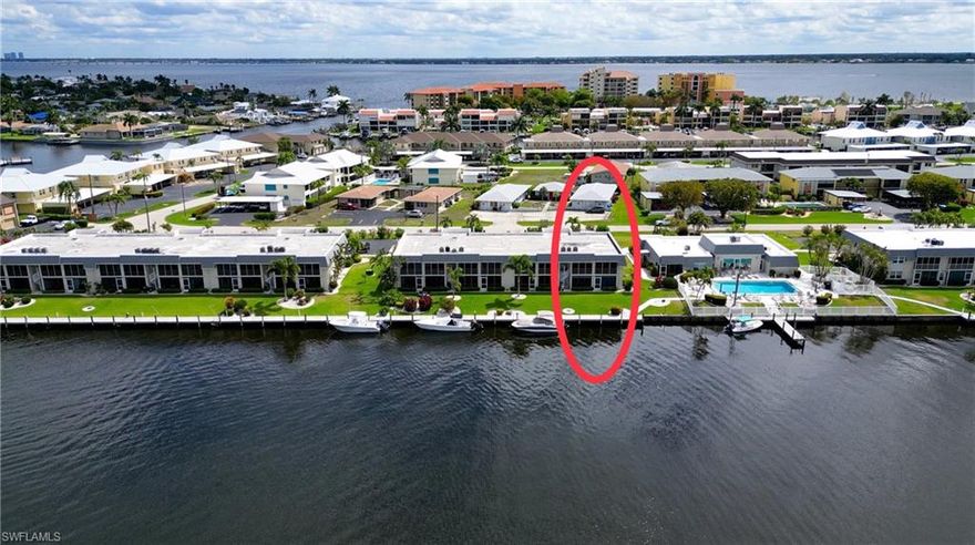 DING DING DING… THIS ONE CHECKS ALL THE BOXES — LOCATION, VIEW, CONDITION AND VALUE — AND THEN SOME! Positioned on the BASIN OF INTERSECTING 200’ WIDE SAILBOAT ACCESS CANALS just a minute from the CALOOSAHATCHEE RIVER, this is one of those rare opportunities where the view simply cannot be duplicated. Wide water in two directions, dolphins playing, fish jumping and sunsets that remind you exactly why you chose Southwest Florida in the first place. If you’ve been searching for that “this is it” moment… this is where it happens! And here’s what makes this one even more compelling… it’s a FIRST FLOOR, END UNIT. More windows, more natural light, more convenience — and a bright, airy GREATROOM floorplan that lives exactly how buyers want today. The additional windows bring the outside in, creating that light and cheerful coastal feel that is so hard to find. Small four unit building in a 40 unit complex. The kitchen has been beautifully remodeled with GORGEOUS MARBLE COUNTERTOPS, kitchen cabinetry with soft-close features, stainless steel appliances and a stylish backsplash that ties it all together. Tile flooring runs throughout the entire unit, offering durability, ease of maintenance and a clean, consistent look. Both bathrooms have been tastefully updated, with the master suite positioned directly on the water — a view to wake up to that never gets old. You’ll appreciate the practical upgrades already handled for you: CPVC PLUMBING (2021), WATER HEATER (12/23), ROOF (2023), plus an IMPACT GLASS SLIDER in the greatroom and another IMPACT SLIDER scheduled for installation in the master suite as well as new storage closet doors on the lanai. Speaking of the lanai— intersecting canal views, wide open water and that constant reminder that you’re living where others vacation. Add in an IN-UNIT WASHER AND DRYER with storage and a classy barn door with function and style. Assigned carport space (#C101) is conveniently located right outside your door, and the unit’s position offers an EASY WALK TO THE POOL AND CLUBHOUSE next door — making everyday living and social gatherings effortless. Furniture is negotiable, offering flexibility for seasonal or full-time use. THE ANCHORAGE CONDO is a true hidden gem with over 800 feet of waterfront, dock space available on a first come, first serve basis, a fishing pier, heated pool overlooking the intersecting canals, and a clubhouse with kitchen, workshop and gathering room designed for year-round social connection. Next door, to the BRAND NEW $16+ MILLION JAYCEE PARK one of Cape Coral’s most beautiful waterfront destinations, featuring a riverfront walking trail, shaded seating, splash area, playground, gazebos, vending and events. Minutes to beaches, shopping, dining, RSW Airport & more. If you’ve been waiting for WIDE WATER, TRUE SAILBOAT ACCESS, END UNIT ADVANTAGE and A REMODELED INTERIOR at a price point that makes sense… this is the one that earns your attention. SEE IT TODAY BEFORE SOMEONE ELSE DOES!