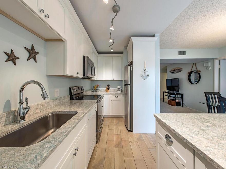 C3120  Great opportunity to own an amazing end unit located west of 41. Close to the beach, dining and shopping at Venetian Village. Tastefully updated baths, and kitchen with beautiful white cabinetry and quartz countertops. Features includes a large walk in closet, separate guest bath, full laundry room in residence, storm shutters, screened lanai off the living area that extends off the master bedroom, and a spacious great room.  Hidden Lake Villas offers resort style amenities, which includes heated swimming pool, tennis courts, pickleball, clubhouse, party room with kitchen, barbecue area, exercise rooms, and community car wash. There is an optional $125.00 annual membership to the Park Shore Association that adds private beach access.  This unit offers everything the Naples life style has to offer at an affordable price.