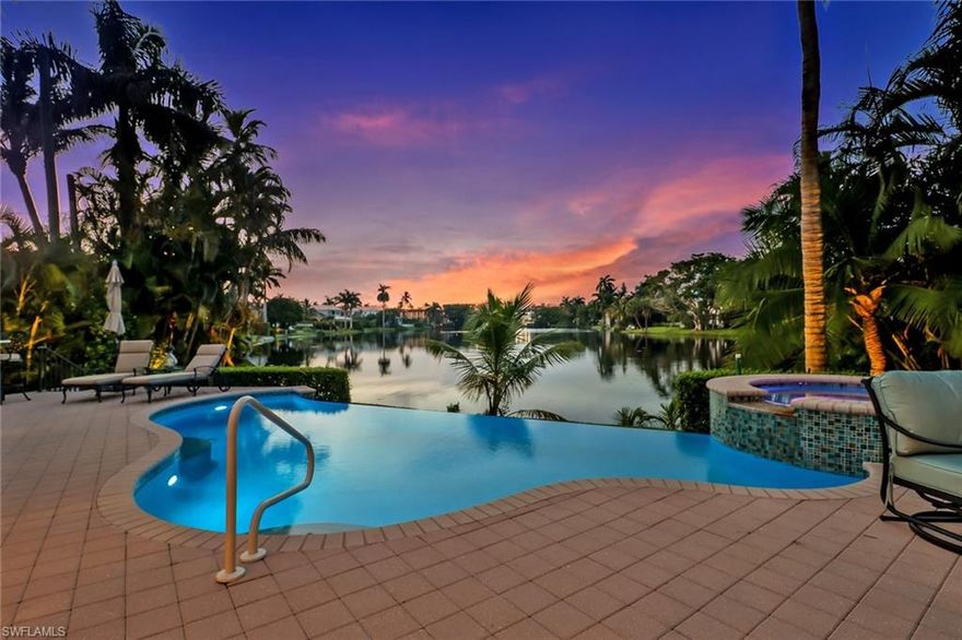 Enjoy living in downtown Naples in this elegant home on Spring Lake. Relax in the recently renovated interiors of this 4,139 square foot home, with classic open floor plan.  Be inspired by the dramatic sweeping views of your infinity pool, calm lake waters, and majestic palm trees. It’s your idyllic  retreat just three blocks from the excitement, shops, restaurants, and services of 5th AVE, and only blocks to the beach. Entertain in style in your great room, gourmet kitchen and lakefront deck with outdoor kitchen, infinity pool and spa.Your guests will enjoy the privacy of second level bedrooms with balcony access and en suite baths.  Take a short stroll to Cambier park for outdoor movie nights, live music at the amphitheater, and lighted tennis courts.  Make the most of your days and evenings, enjoying relaxed living and the variety of entertainment options just steps from your front door.