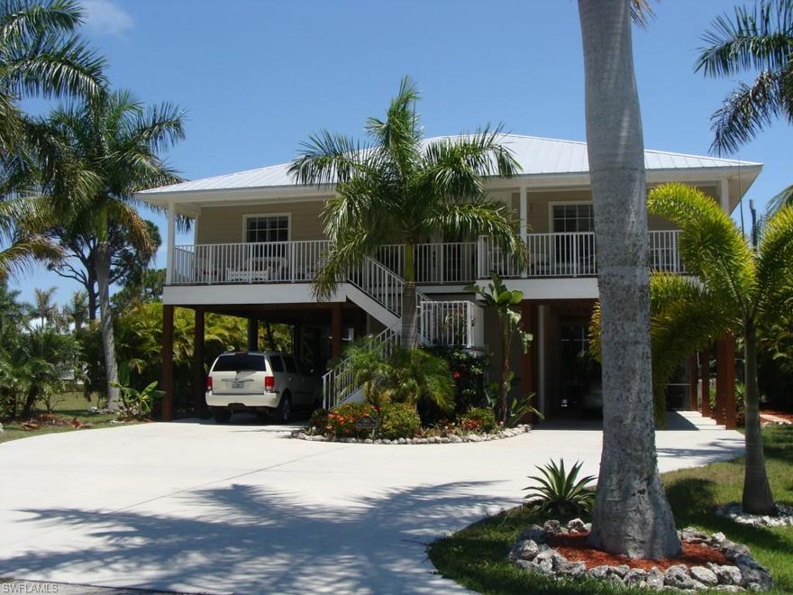 THIS HOME IS ABSOLUTELY GORGEOUS INSIDE AND OUT!! Upstairs has 3 bedrooms, 2 baths, Brazilian Tile and Oak flooring, granite counters, stainless appliances (including a gas stove), walk in pantry and impact windows. Downstairs is the best Florida has to offer with a large screened pool and spa w/ privacy provided by lush landscaping. Great outdoor entertaining area along with a Tiki Bar and small kitchenette and half bath. Home was built with hurricanes in mind with Hardy board exterior, high impact windows. oversized gutters for extra water and the pool cage and house straps exceed code. This lovely community offers a community boat ramp that is minutes to open waters and a private sewer plant.  Do not miss this one-- SEE TODAY!!