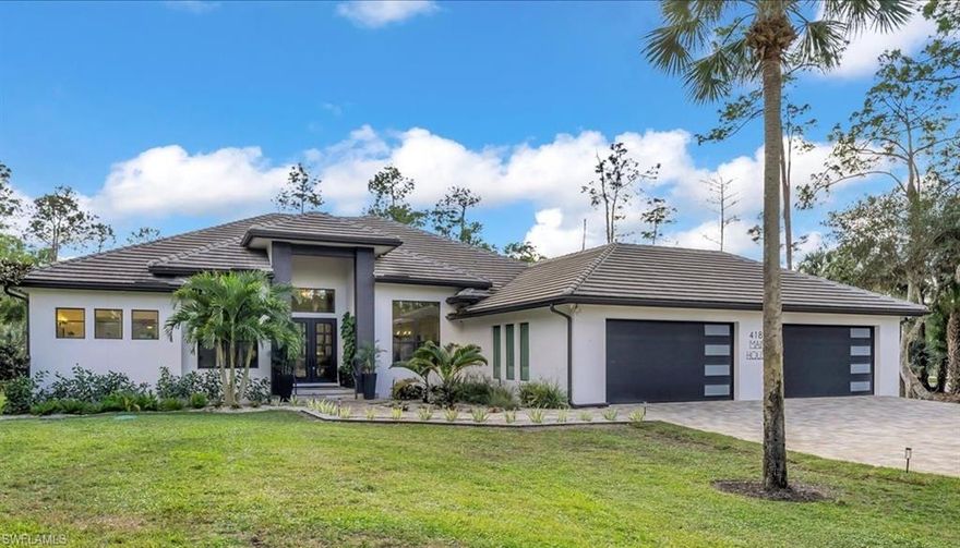 A Rare offering within Collier Woods Estates, this exceptional property features a primary residence and a fully independent guest house on 2.5 wooded acres, delivering privacy, flexibility, and refined living. The 4,560 sq ft main home features five bedrooms and four bathrooms, complimented by a fully residential ADA compliant guest house ideal for extended family, guests, or potential rental income.
Upon entry, soaring ceilings and elegant architectural details create an immediate sense of scale and sophistication. The heart of the home is a striking chef's kitchen designed for both function and entertaining, showcasing two expansive 9-foot islands, premium Cafe appliance with a 5 year warranty, gas cooking, a 48" refrigerator, double ovens, a pot filler, a dedicated coffee station, and a separate bar with ice maker. A large walk in pantry with sliding barn doors, tray ceilings, recessed lighting, wood accent walls, and custom window coverings elevate the homes modern aesthetic.
The primary suite is a private retreat featuring sliding glass doors opening to the outdoor living area creating seamless indoor-outdoor flow.  The spa inspired primary bath offers dual vanities, a soaking tub, dual shower heads, and a Trone Smart bidet toilet with advanced functionality.
The outdoor living spaces are designed for both entertaining and relaxation, featuring an expansive screened lanai with dedicated lounging and dining areas, a fully equipped outdoor kitchen, and a stunning custom pool with a rock waterfall feature and electric heater, creating a private, resort-style retreat with the soothing sound of flowing water for year-round enjoyment.
The residence is equipped with whole-home automation, including surround sound, a security system with recording, and full app-based controls. Additional infrastructure highlights include a 1,000 gallon LP tank, tankless water heater, 2 regularly serviced A/C units, and a Generac whole-house generator, providing comfort and peace of mind year-round. Two double car garages offer ample storage and convenience.
The separate ADA compliant guest house is thoughtfully designed with accessibility in mind, featuring a garage ramp with railing, full kitchen and dining area, dedicated laundry room, two bedrooms, 2 full bathrooms and its own screened lanai. This private residence offers exceptional flexibility, serving as an ideal space for long term guests, live-in support, private accommodations, or a fully self contained residence with strong income potential.
A truly exceptional opportunity to own a thoughtfully designed estate within Collier Woods, offering privacy, flexibility, and a modern comfort in a serene spacious setting.