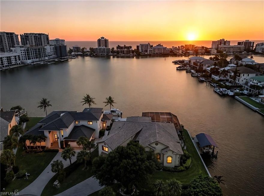 Experience unparalleled waterfront living with 209 feet of private bay frontage—the widest in Vanderbilt Beach’s coveted Conners neighborhood. This rare end lot offers sweeping, unobstructed bay and canal views, bathed in golden sunsets each evening. Elevated 11 feet above sea level, the home’s thoughtfully designed structure provided complete dryness during Hurricane Ian, offering unmatched peace of mind for Florida coastal living. 

Step outside to your seamless negative edge pool that visually merges with the tranquil bay waters, complemented by a brand-new boat dock and 10,000 lb lift installed in 2024—perfect for effortless Gulf access. Recent upgrades include a 2023 roof replacement and automated hurricane shutters, melding durable elegance with modern convenience. Inside, 3,597 sq. ft. feature four bedrooms and four baths, with well-appointed living spaces framed by large windows to capture the stunning water vistas. 

Situated just minutes from world-class Gulf beaches, upscale dining and shopping at Mercato, and the Ritz-Carlton, this home offers a premier blend of privacy, luxury, and access. 431 Palm Ct presents a uniquely expansive waterfront lifestyle in one of Naples’ most desirable enclaves, thoughtfully curated for both relaxation and entertaining.