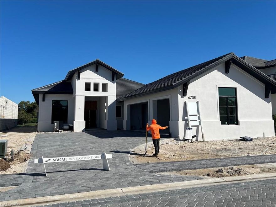 FULLY FURNISHED HOME READY SPRING 2026! Seagate Development Group and Theory Design present the professionally designed and furnished Laguna Model Home in Palisades, one of Seagate’s newest, gated communities in the heart of Naples. This custom home is a collaboration between Seagate Development Group and Theory Design with Architecture by JMDG Architecture, and custom landscape & hardscape design by Outside Productions. Enjoy a coastal cottage design with off white, neutral and slate tones, warm European White Oak floors, wood beam ceilings and decorative wall moldings. This custom home features 3 bedrooms, study, 3 full and 2 half baths, and an oversized 3-car garage. The outdoor living area features electric roll down screens, tongue and groove stained ceiling, outdoor kitchen, stone fireplace, lounge area, pool bath, custom pool with spa and lush landscaping. The home has an open floor plan with trimmed tray ceilings throughout. The gourmet kitchen includes custom cabinetry, with glass upper cabinets with lighting, tile backsplash, custom hood, under cabinet lighting, island with natural stone countertop, paneled Sub Zero/Wolf appliance package, windows for natural lighting, and walk-in pantry with cabinetry, refrigerator, and ice maker. The great room includes stained wood beam ceilings, decorative wall molding and a bar with an undercounter beverage refrigerator. The master suite features a sitting area with sliding glass doors leading to the covered lanai. The master bathroom features honed marble floors and comes equipped with Kohler plumbing fixtures including 2 private water closets, soaking tub, spacious shower with 3 showerheads and a linen closet. Additional luxury features include 9.45” European White Oak wood floor throughout, custom built-in closets, 1 ¾” solid interior doors, Emtek door hardware, linear HVAC diffusers in common areas, level 5 drywall, double pane Andersen impact windows & doors, Control4 home automation system, sound system, spray foam insulation, custom iron front door, natural gas, lush landscaping, and interior designer selected custom light fixtures and furnishings. Palisades is an enclave of 25 custom homes situated in a premier Naples location with abundant amenities. Palisades is only minutes away from Mercato, Waterside Shops, 2 Ritz-Carltons, and other exceptional shopping, dining, and beachfront destinations. Seagate’s portfolio of companies specialize in custom homes, renovations, interior design, estate management, and land development. Together, bringing exceptional concierge levels of service to everything we do. SALES CENTER OPEN DAILY.