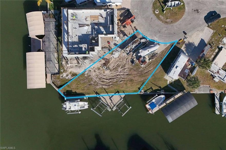 Don't miss this GEM. Located at the end of the canal in the cul-de-sac overlooking the natural mangrove preserve. Over 4,000 sq ft lot with 80ft of seawall to build your custom home or a modular home. The homesite comes with water & sewer along with 3 10,000K boatlifts and composite decking. St James City is golfcart friendly. It also boasts the best worldclass fishing and is just a short boat ride to the outer islands & Fort Myers beach. Now if you really want some space the adjoining lot is also available at 3941 blueberry & now you have over 130ft of waterfront paradise. check out the virtual tour.