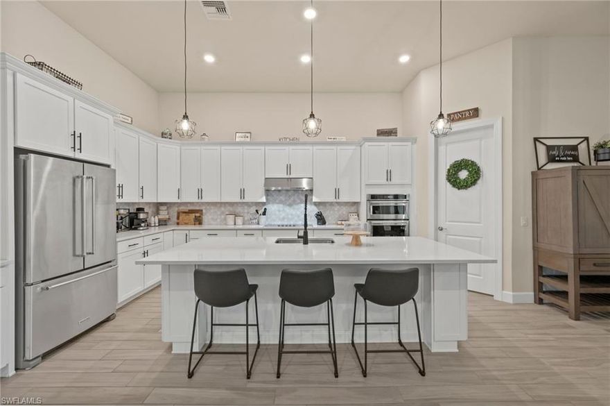 Welcome to your private retreat in the highly sought-after, gated community of Corkscrew Shores—where luxury living meets an active, resort-inspired lifestyle. Centered around a breathtaking 240-acre lake, residents enjoy kayaking, canoeing, and electric or wind-powered boating, along with world-class amenities including a resort-style pool and spa, state-of-the-art fitness center, pickleball, tennis and bocce courts, scenic walking paths, and the on-site Captain’s Club restaurant and bar. Additional amenities include a multi-purpose activity room, movement studio, massage therapy room, playground and picnic pavilion, and sports field, all complemented by a full calendar of clubs and social events that create a vibrant, connected community. This beautifully appointed Stonewater model offers 3 bedrooms + den and is perfectly positioned to enjoy it all—just a short walk to the community’s exceptional amenities. The spacious gathering room with coffered ceilings flows seamlessly into the heart of the home—the upgraded kitchen—featuring quartz countertops, 42” upper cabinetry, stainless steel KitchenAid appliances with built-in oven and microwave, and a walk-in pantry. Multiple dining options include a formal dining space, casual breakfast nook, and breakfast bar—ideal for both entertaining and everyday living. Stylish design details are found throughout, including custom wall accents and plantation shutters. A thoughtfully designed den adds valuable flex space, perfect for a home office, workout room, guest space, or whatever best fits your lifestyle. The owner’s suite serves as a relaxing retreat with a tray ceiling, dual vanities, walk-in shower, and an oversized walk-in closet. A private guest wing with pocket door separation and its own full bath provides comfort and privacy for visitors. Step outside to your own backyard oasis featuring a private pool and an expansive covered lanai, designed for effortless outdoor living, with ample space for dining, lounging, and entertaining year-round. The 3-car garage is designed with both function and lifestyle in mind, offering epoxy floors, overhead storage, an EV charging outlet, and plenty of room for a golf cart—ideal for enjoying all that Corkscrew Shores has to offer. Hurricane impact windows and doors provide added peace of mind. With NO CDD, NOT in a flood zone, and an exceptional blend of location, lifestyle, and amenities, this is a rare opportunity to own in one of Estero’s most sought-after communities. Discover for yourself what makes Corkscrew Shores truly special. Schedule your private showing to experience it firsthand.