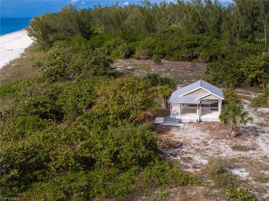 Spectacular Keewaydin Island beachfront retreat. More than just a vacant lot this 2 acre parcel has a dock and  1000 foot cleared path to the beach with a small unique beach side custom cabana on property.