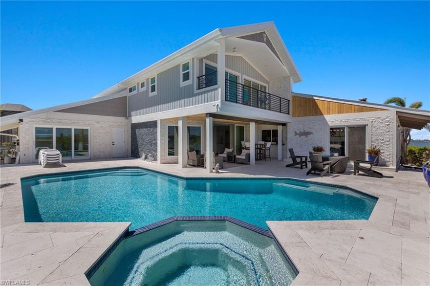 MOVE IN READY! BAYFRONT FMB. A BIG BOATER'S DREAM HOME featuring astounding 220 ft+ of waterfront!  Offering 4 Beds with Ensuite baths + Flex/5th bedroom + Pool Bath. This home is perfect for welcoming Big families & entertaining large events. Panoramic views of beautiful Estero Bay from your Waterfront Estate home here on Fort Myers Beach. Open Concept Kitchen & Dining areas & Florida room opening to the Bay, & Living room that flows into the Pool deck. Waterfront living at its finest! The Main dock stretches out into the Bay & has a Captains Walk with 2 docks. There is also a Canal side Boat slip. Inside the  welcoming entrance, you will be astonished with the openness of the entire home, with floor to ceiling windows throughout, drawing you to the pool/hot tub and the amazing smooth waters of the bay. The Master Ensuite bedroom offers relaxing Bay & Pool views from the 2nd floor & a private balcony to enjoy watching the Boats. 2nd floor also has a Guest Ensuite. The main floor boast 2 additional beds/baths plus flex/5th bedroom. An easy stroll to the Beach to enjoy Dreamy Sunsets. Renovation completed, with NEW Flooring, NEW Kitchen & NEW Furniture. Photos updated as of 3/16/23