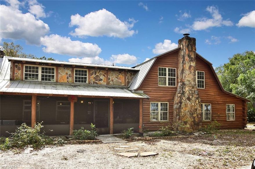 Rustic country living on 10 acres CAN still be found in SW Florida. This one-of-a-kind 4BR+Den, 2.5BA log-and-stone home is the perfect getaway off the beaten path! Away from the 'hustle & bustle,' imagine enjoying the soft whisper of the wind in the tall shade trees as you watch the kids & pets play in the spacious yard. Rest assured they're protected by a long winding driveway and perimeter fencing with a solar-activated security gate. Rainy day? Take shelter on the large screened porch, or come inside and enjoy either of the 2 ground floor wood-burning fireplaces with large stone hearths.  Travertine flooring accents the neutral countertops, two-toned wood cabinetry and large farm sink in the sunny kitchen.  Log interior walls & ceiling surround you in cozy comfort, and three adjoining multi-purpose rooms off of the great room can be used for private workspace, a crafts room, a library, etc. Upstairs you'll find beautiful new waterproofed dark oak wood flooring, a stunning vintage clawfoot tub in the owner's bath, and new toilets and vanities, all under a BRAND NEW GREEN METAL ROOF.  Outbuildings include a barn & workshop, and a fully-fenced pond is "the cherry on top!"